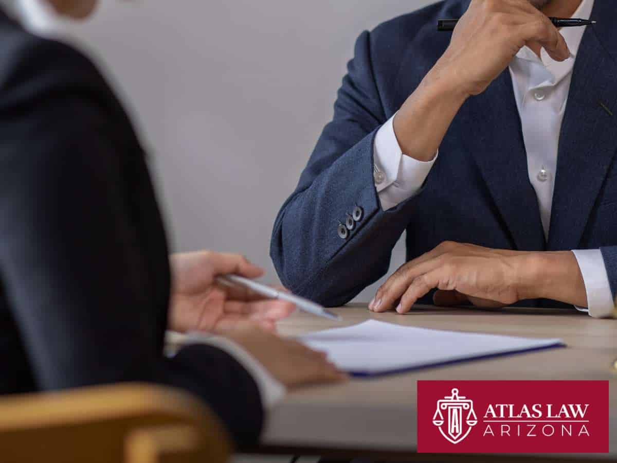 Two professionals in discussion over documents that explain Arizona’s Standout Bankruptcy Procedures