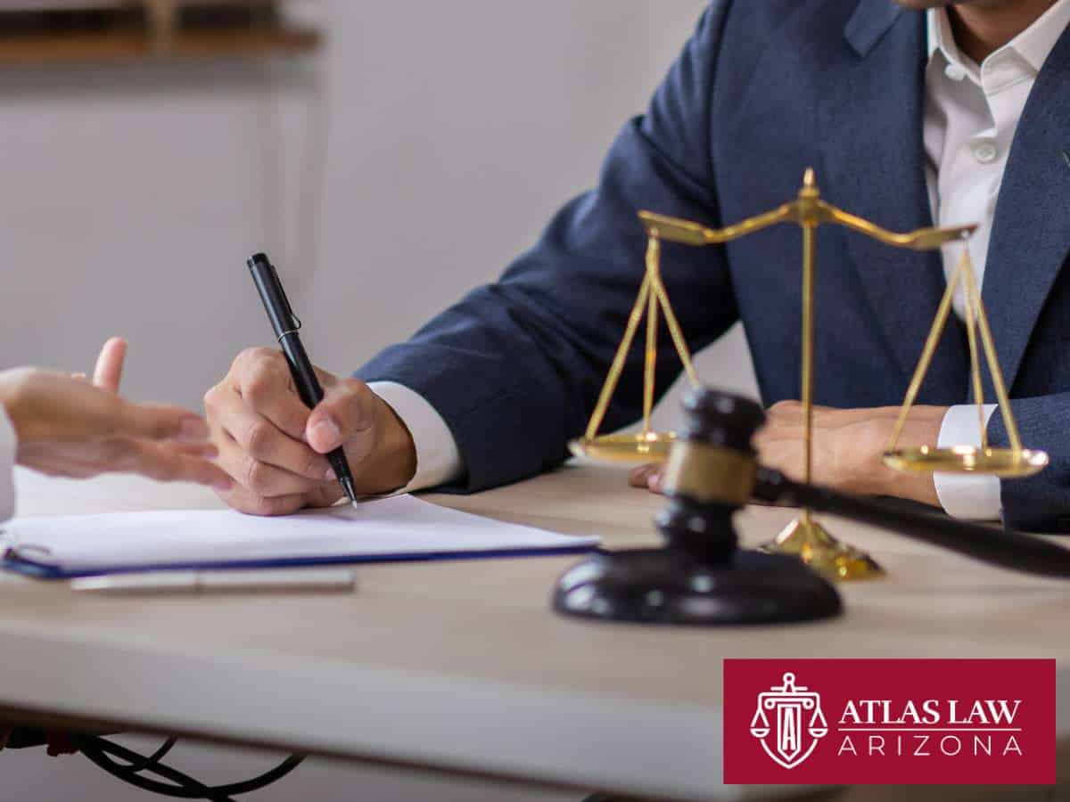 Attorney discussing Debt-To-Income Ratio with a client, with scales of justice and gavel on the table