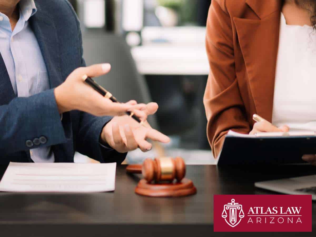 Lawyers discussing Chapter 11 Bankruptcy options, with legal documents and a gavel on the table, at Atlas Law Arizona.