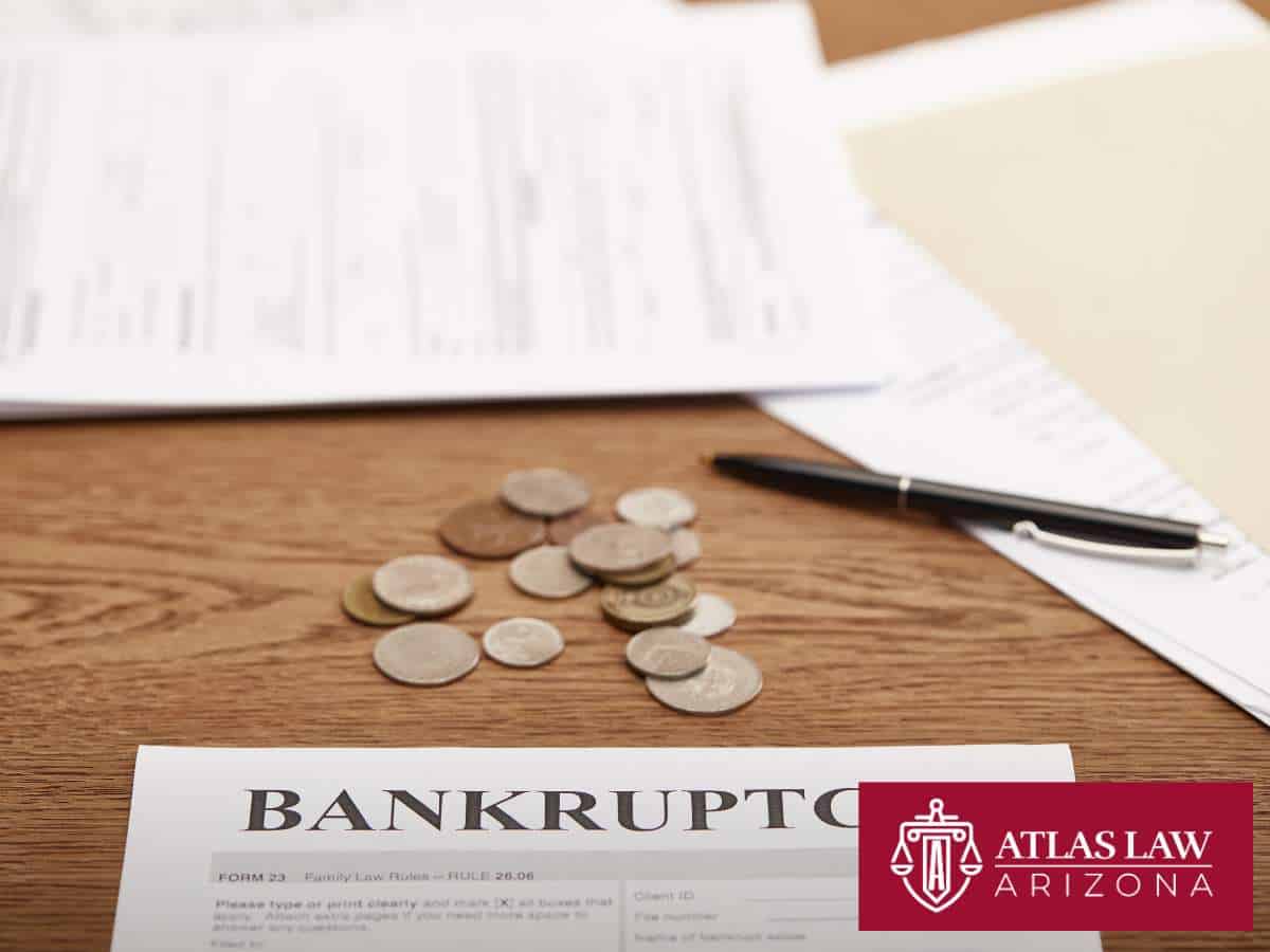 Bankruptcy Questions with legal forms and coins on a desk.